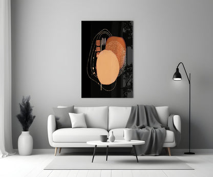 Abstract black glass wall art with orange and peach circles and fork design, displayed above white sofa in modern living room.