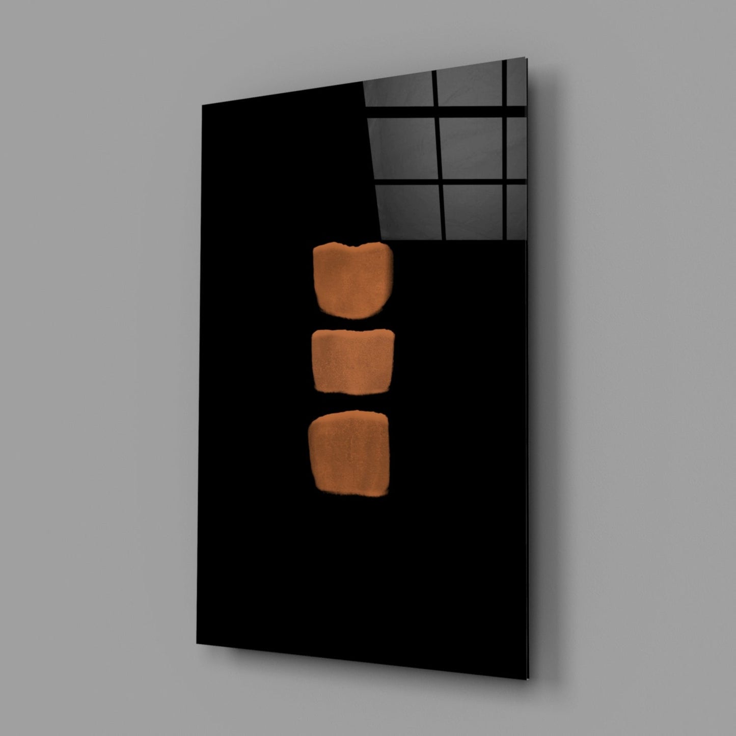 Black glass wall panel with three orange-brown rounded rectangles arranged vertically, displayed at an angle against gray background.