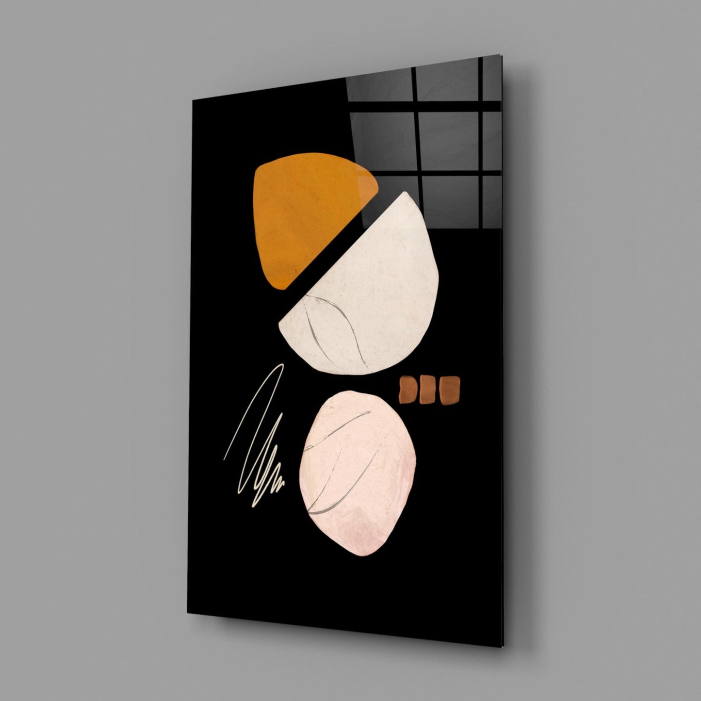 Abstract acorn glass wall art displayed at an angle, showing orange and cream shapes with line details on black background.