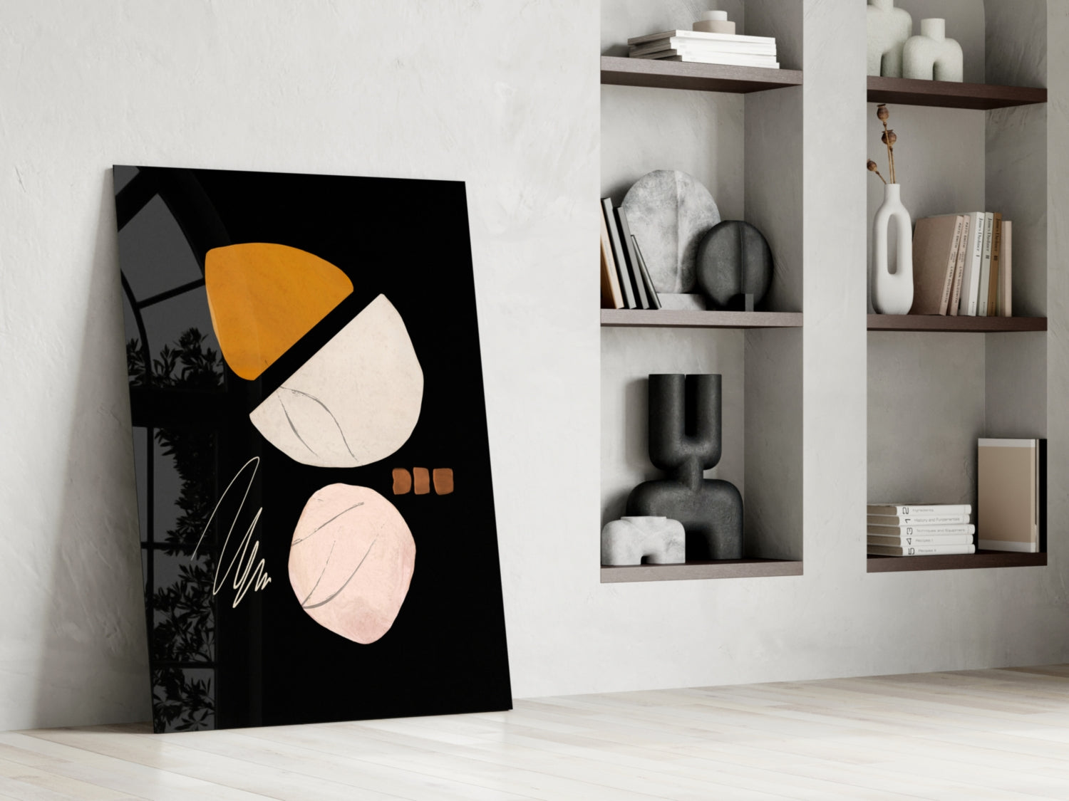 Abstract acorn glass wall art leaning against white wall beside built-in shelving with decorative objects and books.