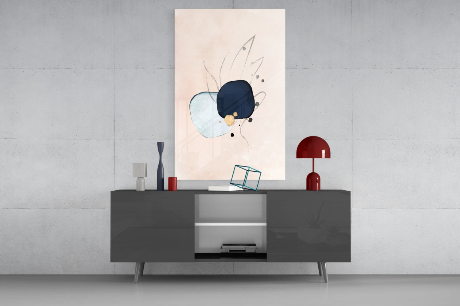 Abstract hand glass wall art with light blue and dark navy circles and line details displayed above gray sideboard with red lamp and decorative objects.