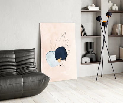 Modern living room with abstract glass wall art leaning against white wall, featuring blue and light blue watercolor shapes with line details.