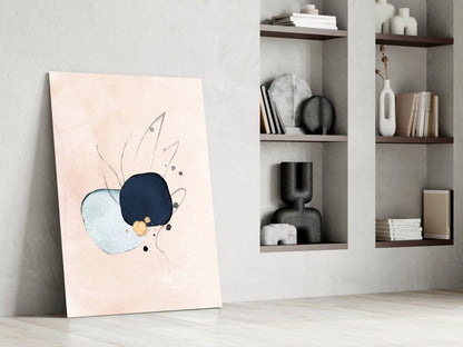 Abstract glass wall art leaning against white wall beside shelving unit, featuring blue, navy, and gold circular design with line details on cream background.