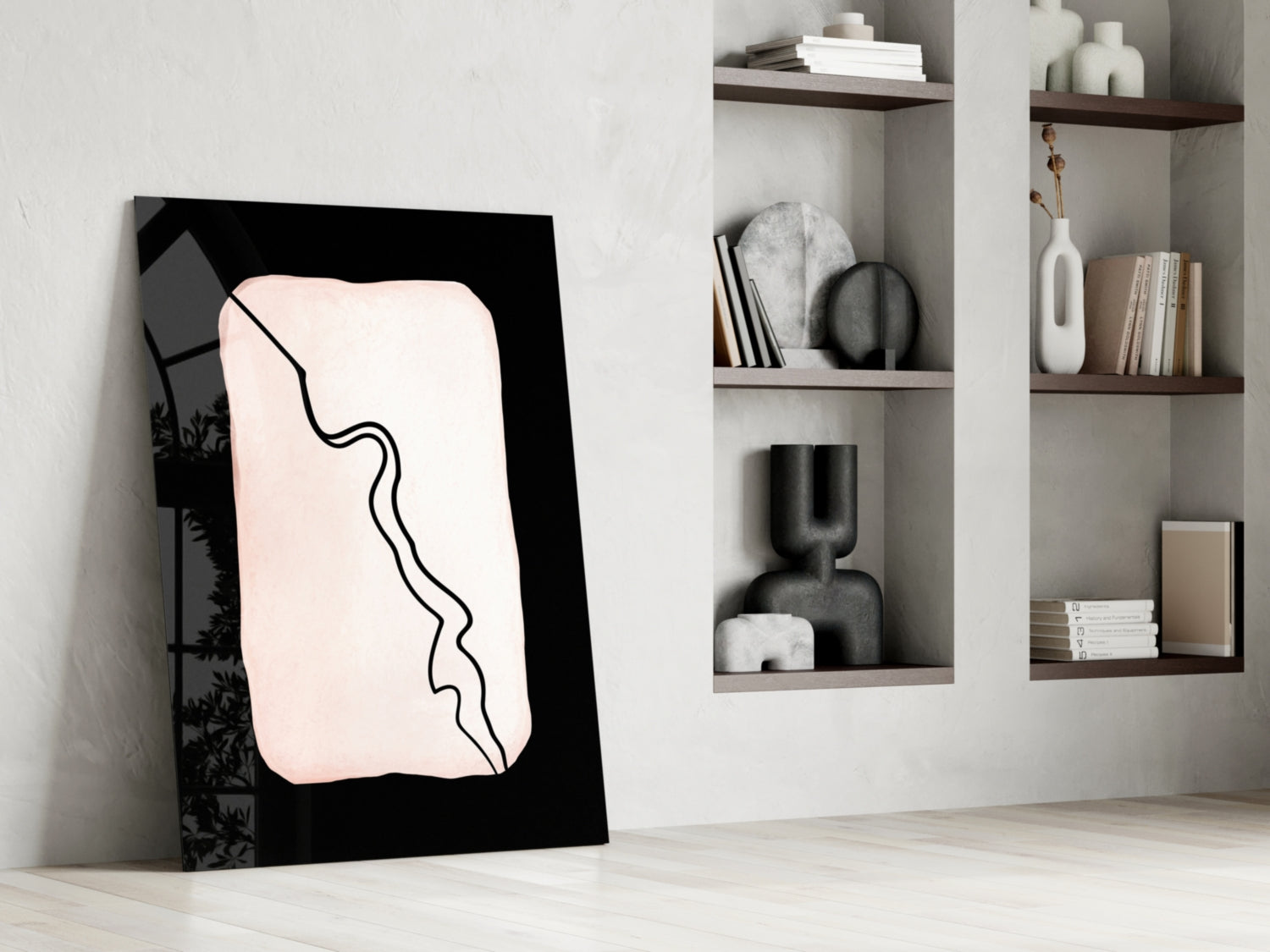 Modern minimalist glass wall art with black frame and cream-colored abstract line drawing, displayed against white wall with wooden shelving.