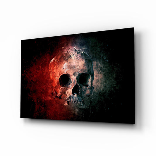Angled perspective of glass wall art displaying a skull with red-orange glow on left side transitioning to dark teal on right against black background.