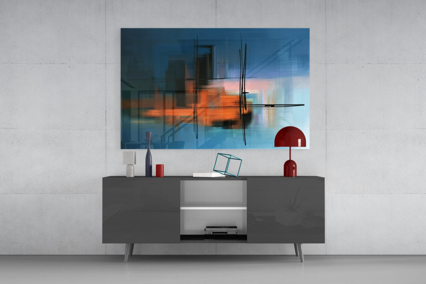 Modern living room setup with abstract glass wall art featuring blue, orange, and black striped design mounted above gray media console with red desk lamp.