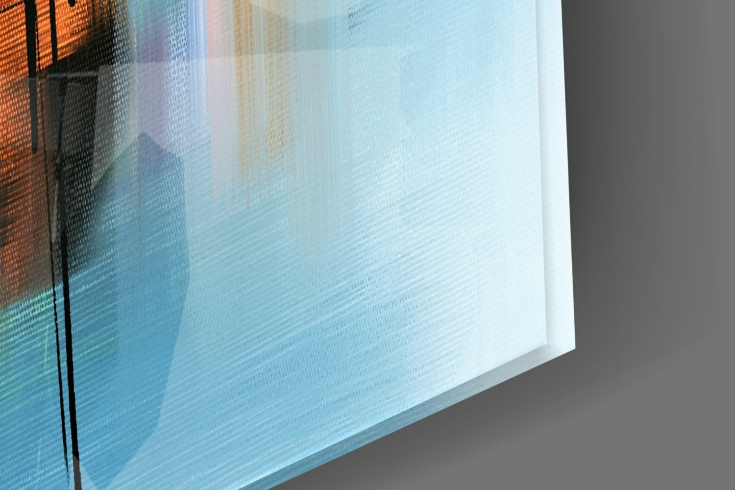 Close-up angled view of layered glass art showing orange, blue, and white translucent panels with textured surfaces.