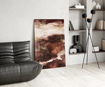 Abstract Earth Glass Wall Art in warm browns and creams displayed in a modern living room with black leather furniture and shelving.