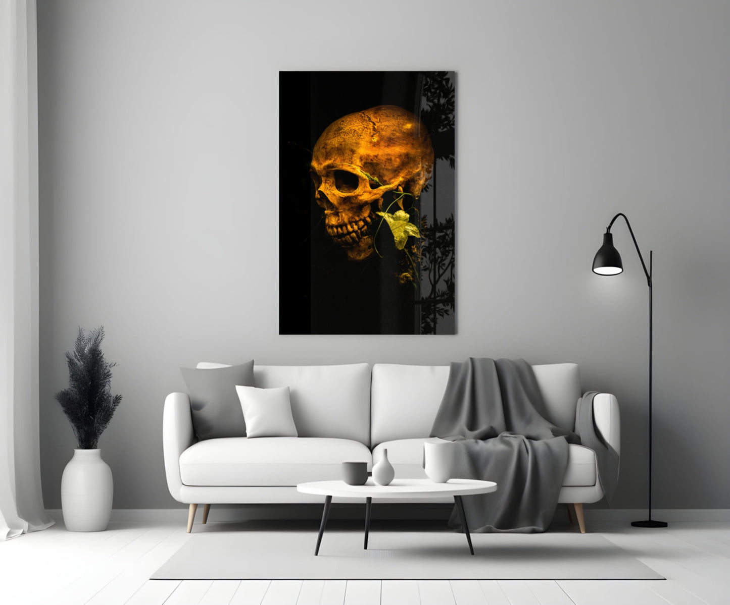 Golden skull with yellow flower on black background, displayed on white living room wall above sofa.