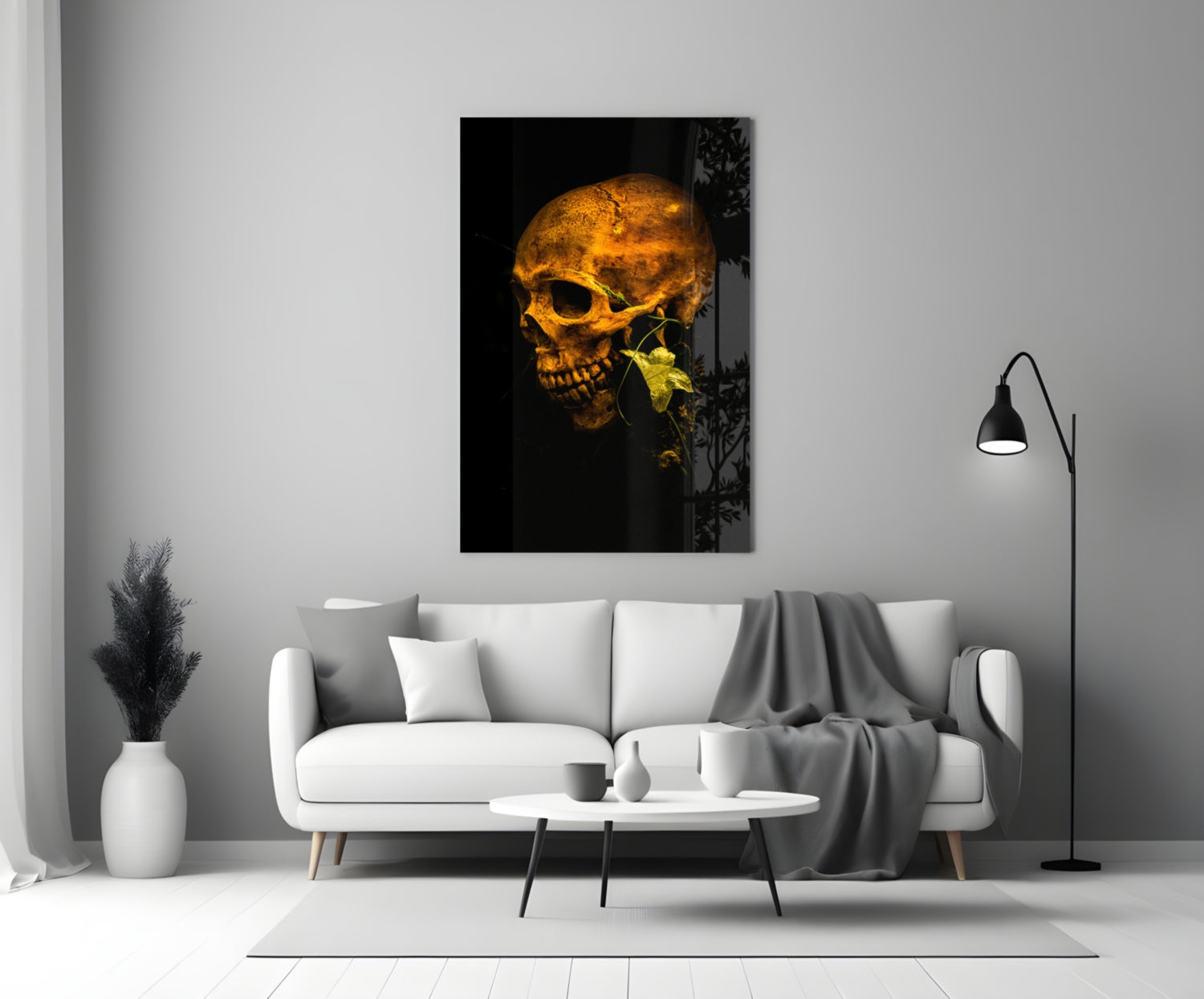 Golden skull with yellow flower on black background, displayed on white living room wall above sofa.