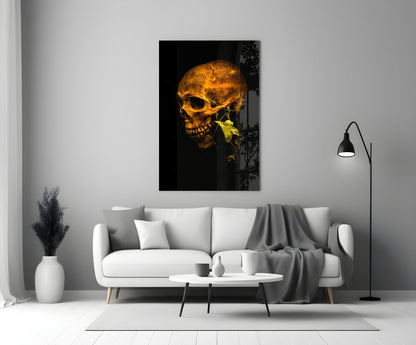 Golden skull with yellow flower on black background, displayed on white living room wall above sofa.
