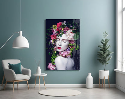 Modern living room with teal walls displaying a floral portrait glass art print featuring a woman with pink and purple flowers, surrounded by minimalist furniture and plants.