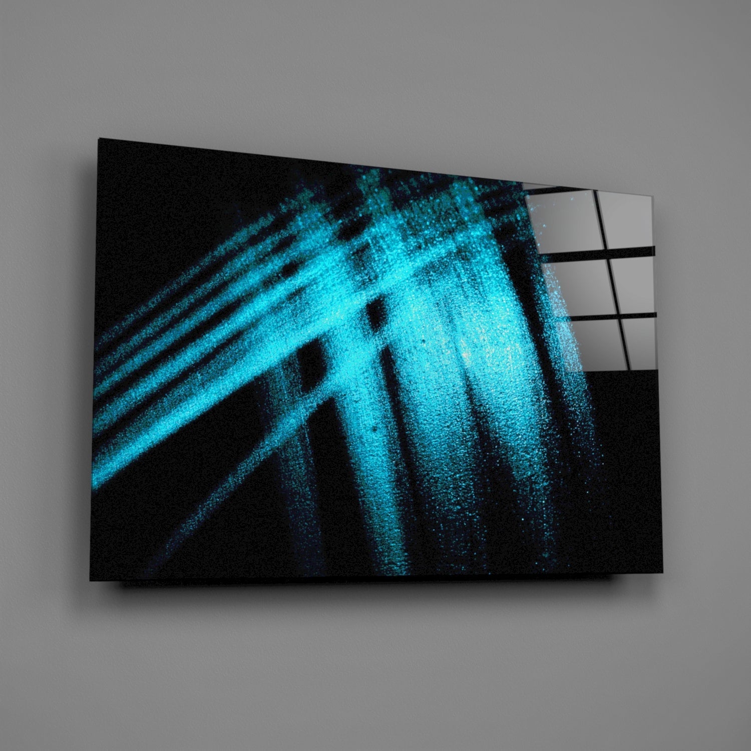 Blue Lights Glass Wall Art displayed at an angle showing cyan diagonal light streaks on black background with metallic frame edge visible.