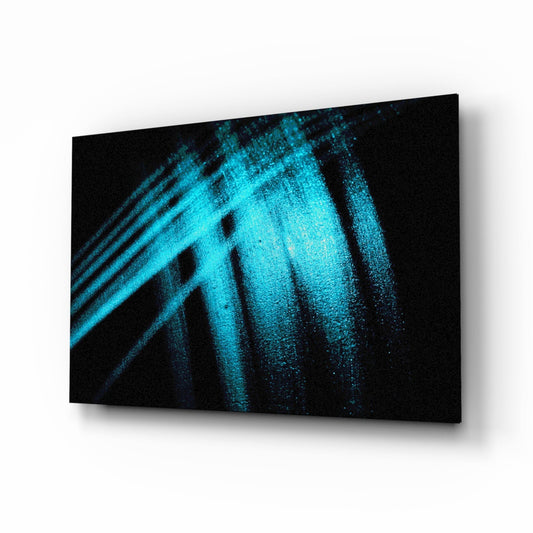 Three-dimensional perspective view of glass wall art displaying bright turquoise light streaks and particles against black background.