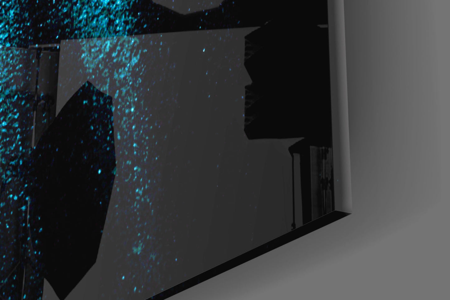 Glass wall art installation with cyan digital particles dispersing across dark surfaces, shown in interior corner setting.