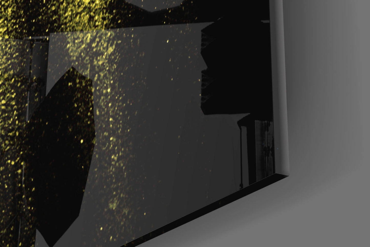 Angled interior view of illuminated yellow speckled glass wall panels mounted on dark surfaces against grey walls.