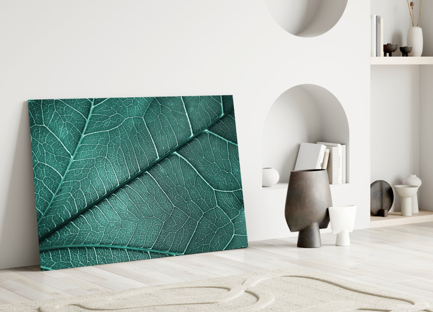 Teal glass wall art with detailed leaf vein texture leaning against white wall in minimalist interior setting.