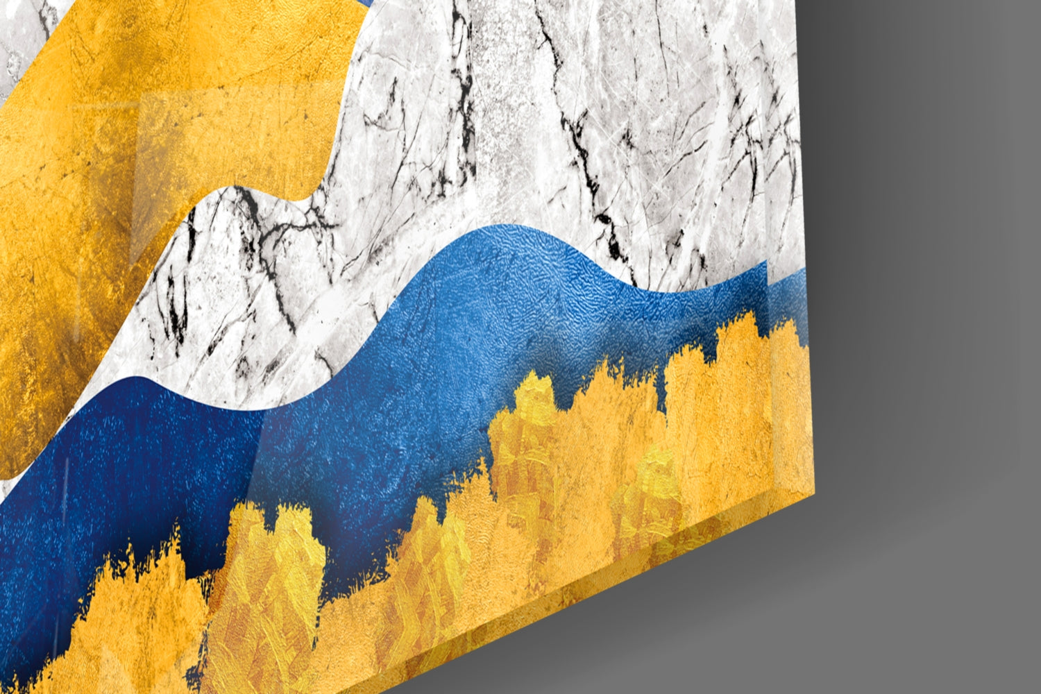 Angled view of glass wall art featuring layered mountains in blue, yellow, and white with textured surface detail.