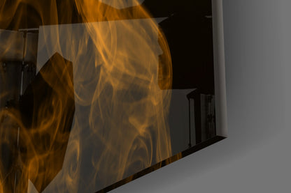 Close-up angled view of translucent orange smoke glass wall art panel with swirling amber and gold patterns against gray background.