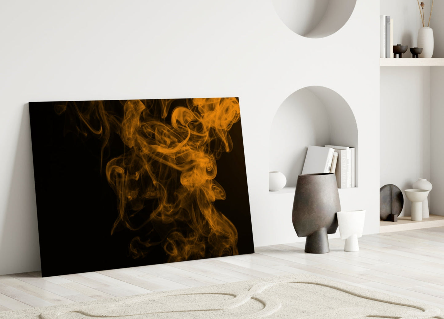 Orange and black smoke swirls on glass panel leaning against white wall in minimalist room setting.