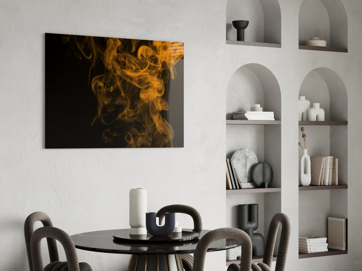 Orange smoke swirls against black background on glass panel displayed above dining table in modern interior.