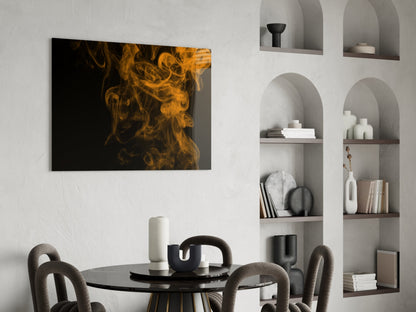 Orange smoke swirls against black background on glass panel displayed above dining table in modern interior.