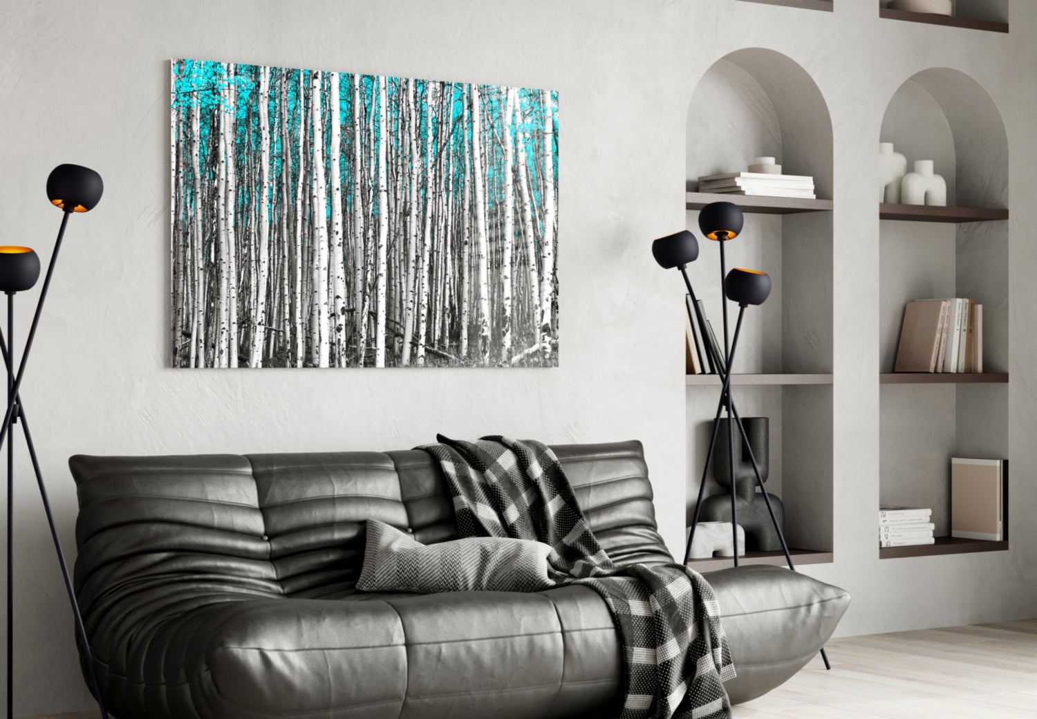 Blue Forest Glass Wall Art depicting birch trees in turquoise and white tones, displayed above a black leather sofa in a modern living room.