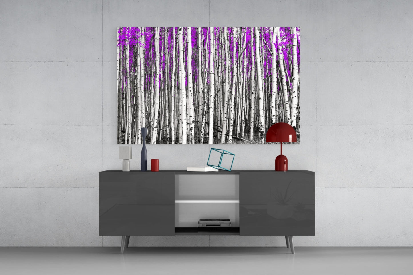 Purple forest birch trees with red sun accent displayed on white wall above dark media console.