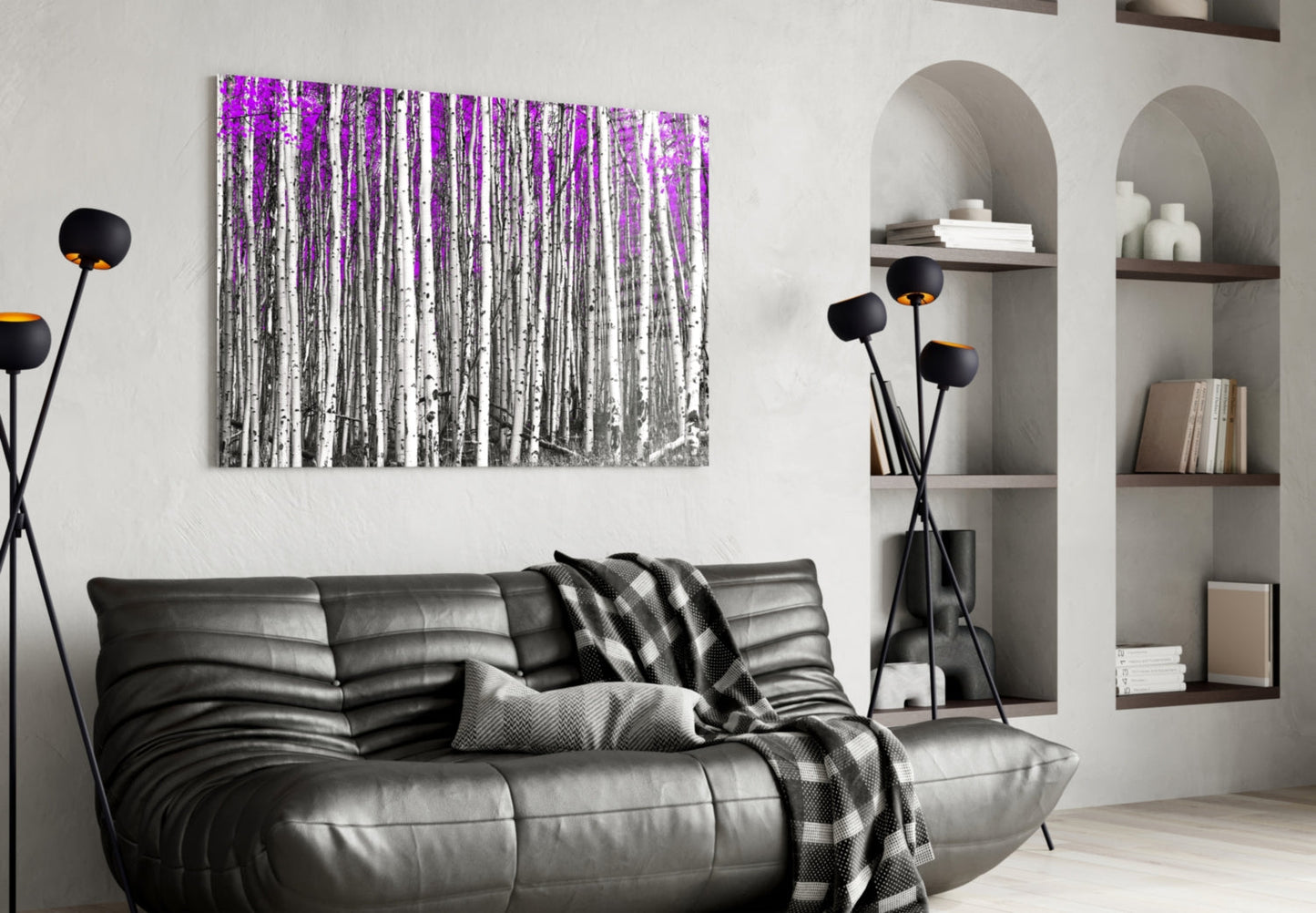 Modern living room with black leather sofa displaying pink and white birch forest glass wall art above.
