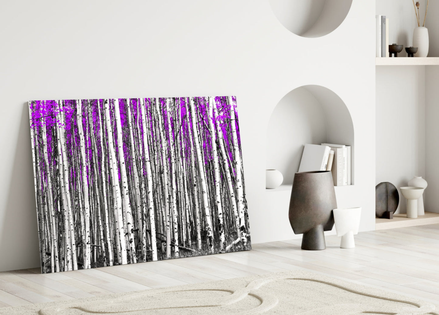 Purple and white birch forest glass wall art leaning against white wall in minimalist room setting.
