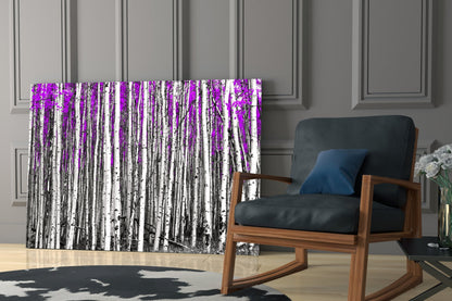 Glass wall art featuring white birch trees with vibrant magenta overlay displayed in modern living room setting.