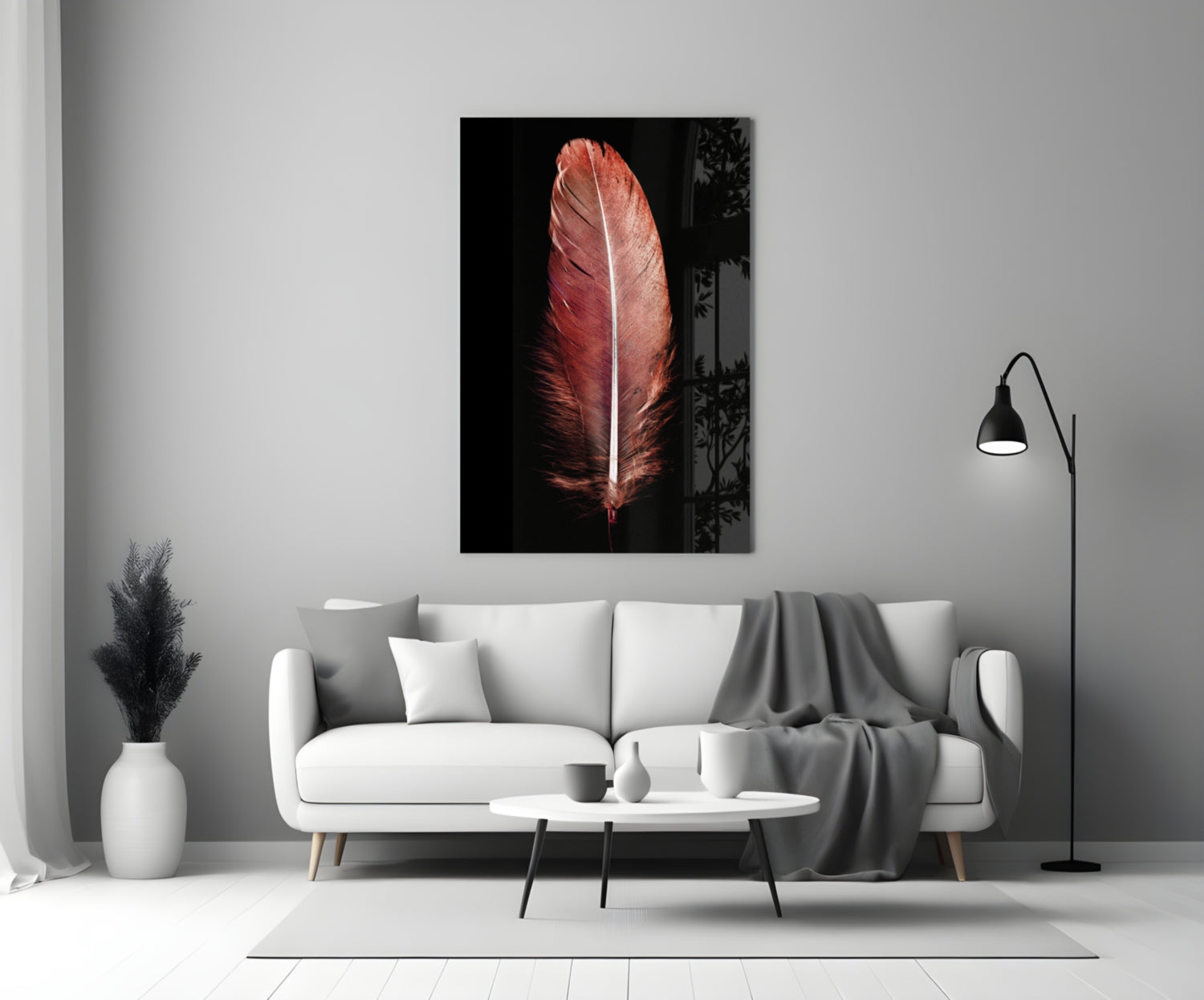Red feather with white center vein displayed as glass wall art above white sofa in modern living room setting.