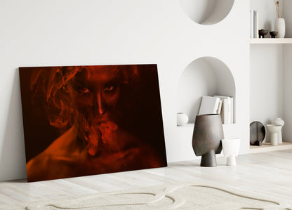 Red and orange toned glass art leaning against white wall in minimalist interior with sculptural decor and shelving.