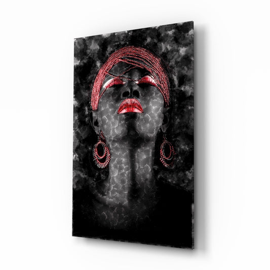 Portrait glass wall art showing woman's face with red lips and headwrap against dark smoky background, displayed at an angle.