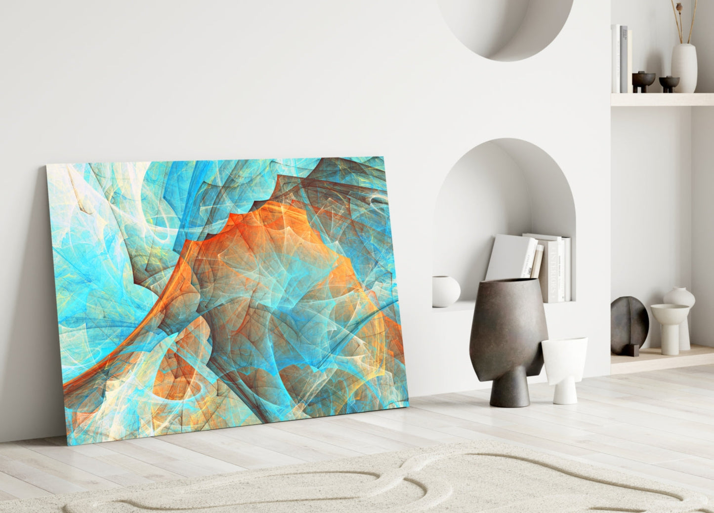 Colorful glass wall art featuring layered blue, orange, and turquoise abstract patterns leaning against a white wall in a minimalist interior setting.
