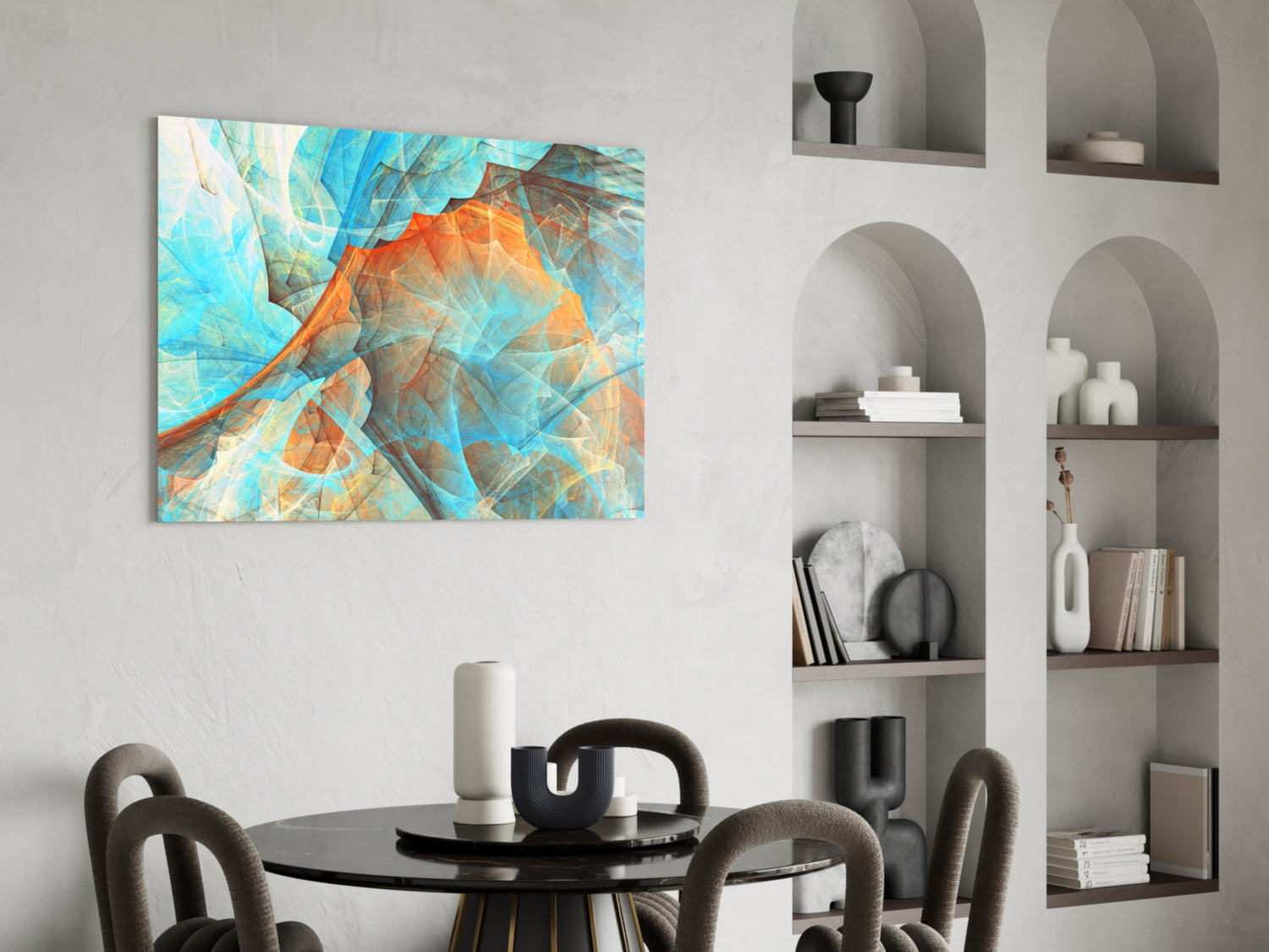 Abstract glass wall art with blue, orange, and turquoise layered geometric patterns displayed above a dining table.
