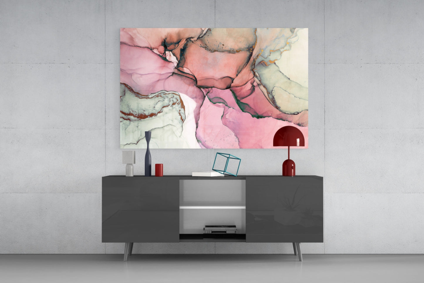 Pink marble glass wall art with cream and tan veining displayed above a dark console table in a modern interior setting.