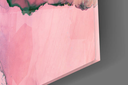 Close-up angled view of pink marble glass art with dark green and black veining at top edge.