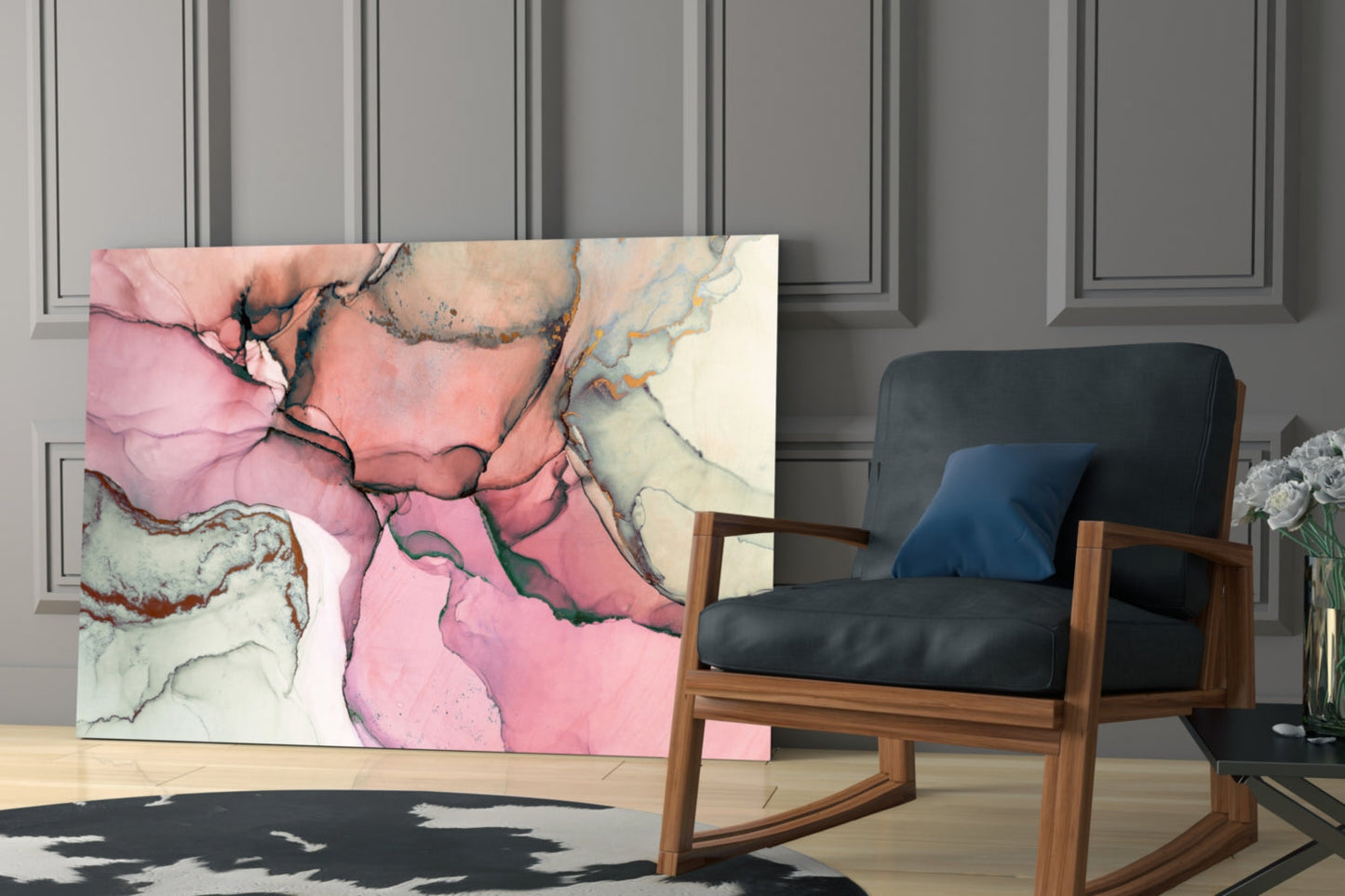 Pink and cream marbled glass wall art displayed leaning against wall beside wooden rocking chair in modern interior.