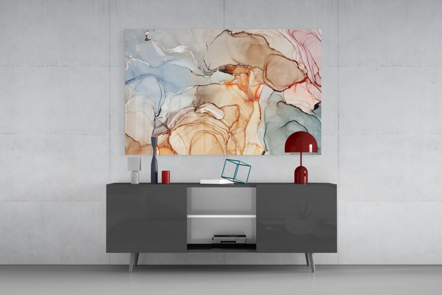 Abstract marble glass art with blue, beige, orange, and red fluid patterns displayed above a dark gray media console in a modern interior setting.