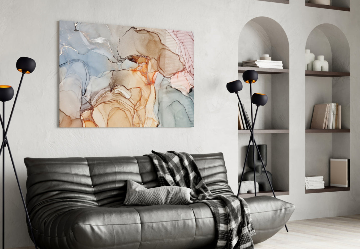 Soft marble pattern glass wall art featuring pastel blue, orange, and beige watercolor swirls displayed above a black leather sofa.