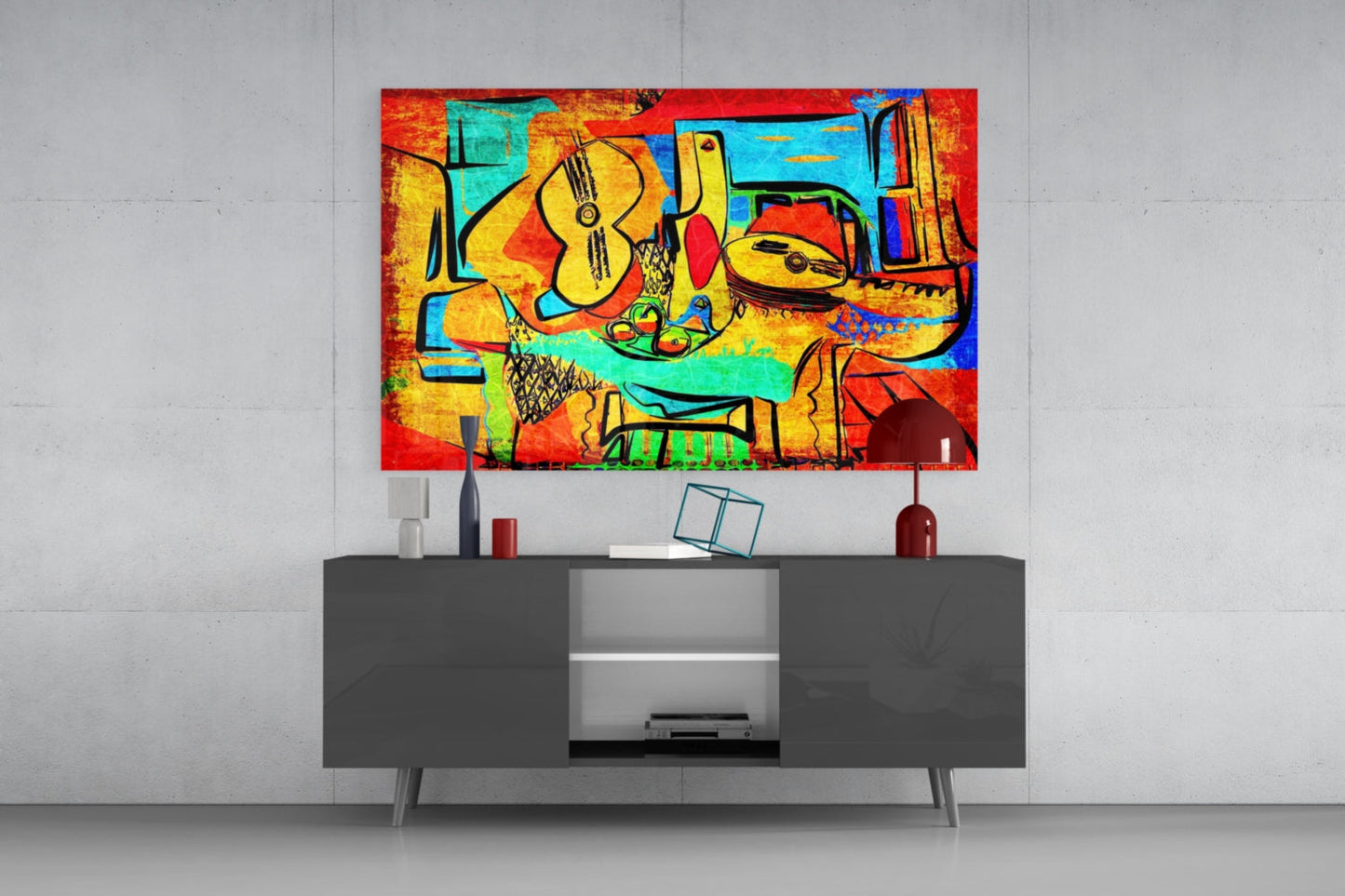 Colorful abstract glass wall art featuring musical instruments and vibrant reds, yellows, and blues displayed above a dark media console.