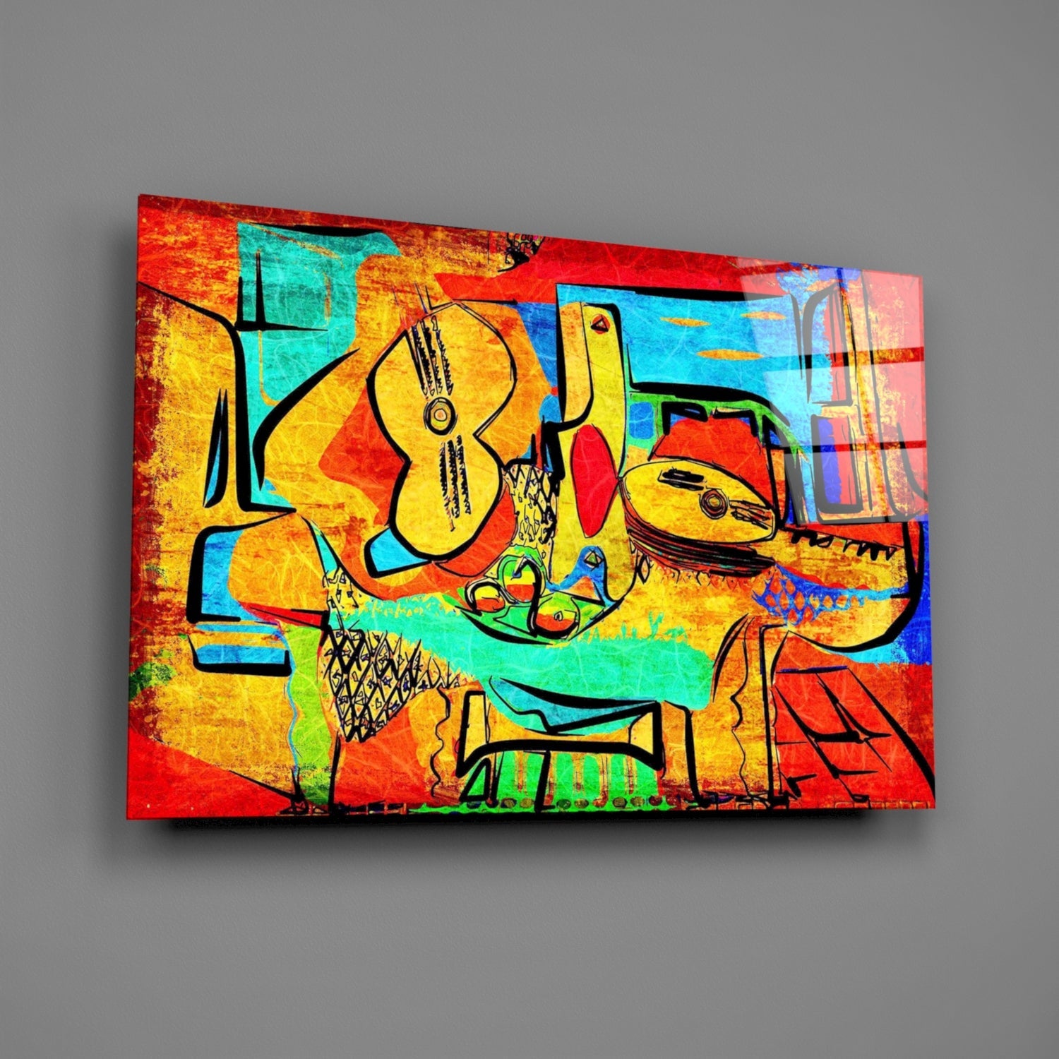 Vibrant abstract glass wall art depicting stylized yellow cellos with black outlines on multicolored red, blue, cyan, and yellow background, displayed at angled perspective against gray wall.