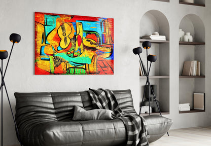 Vibrant abstract cello glass wall art in reds, yellows, and teals displayed above black leather sofa in modern living room.