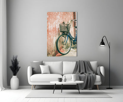 Bicycle Basket Glass Wall Art displayed above white sofa in minimalist living room with gray throw blanket and black floor lamp.