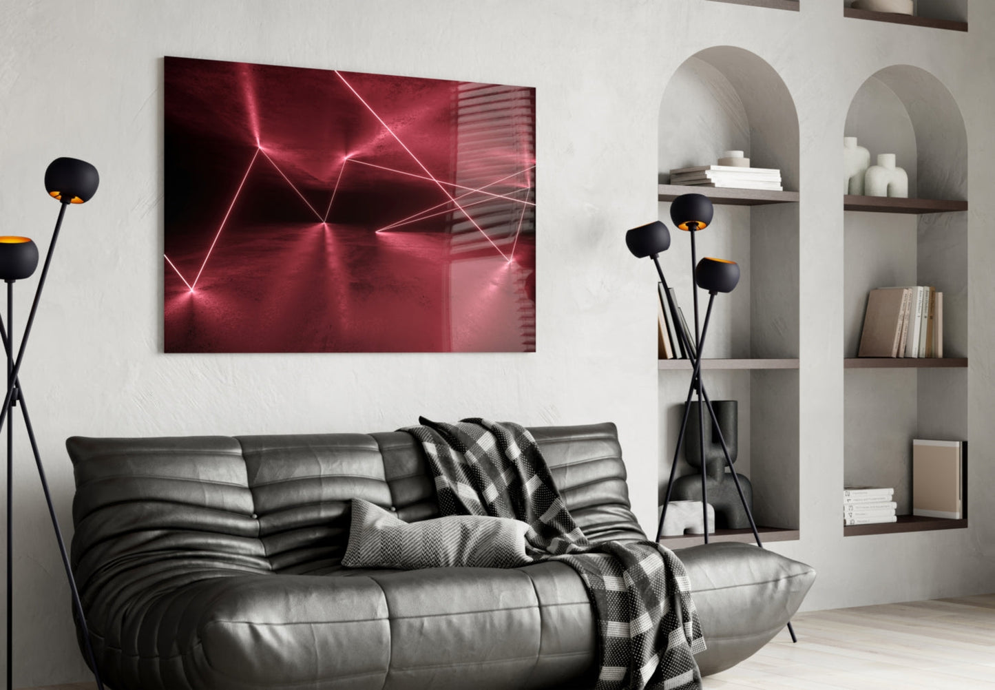 Modern living room with black leather sofa displaying red neon geometric glass wall art above it beside built-in shelving.
