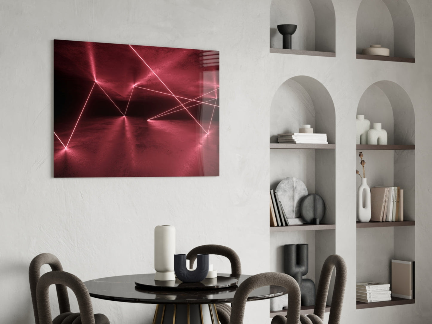 Modern dining room with glowing pink neon geometric glass wall art above round black table and curved chairs.