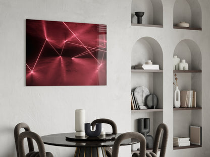 Modern dining room with glowing pink neon geometric glass wall art above round black table and curved chairs.