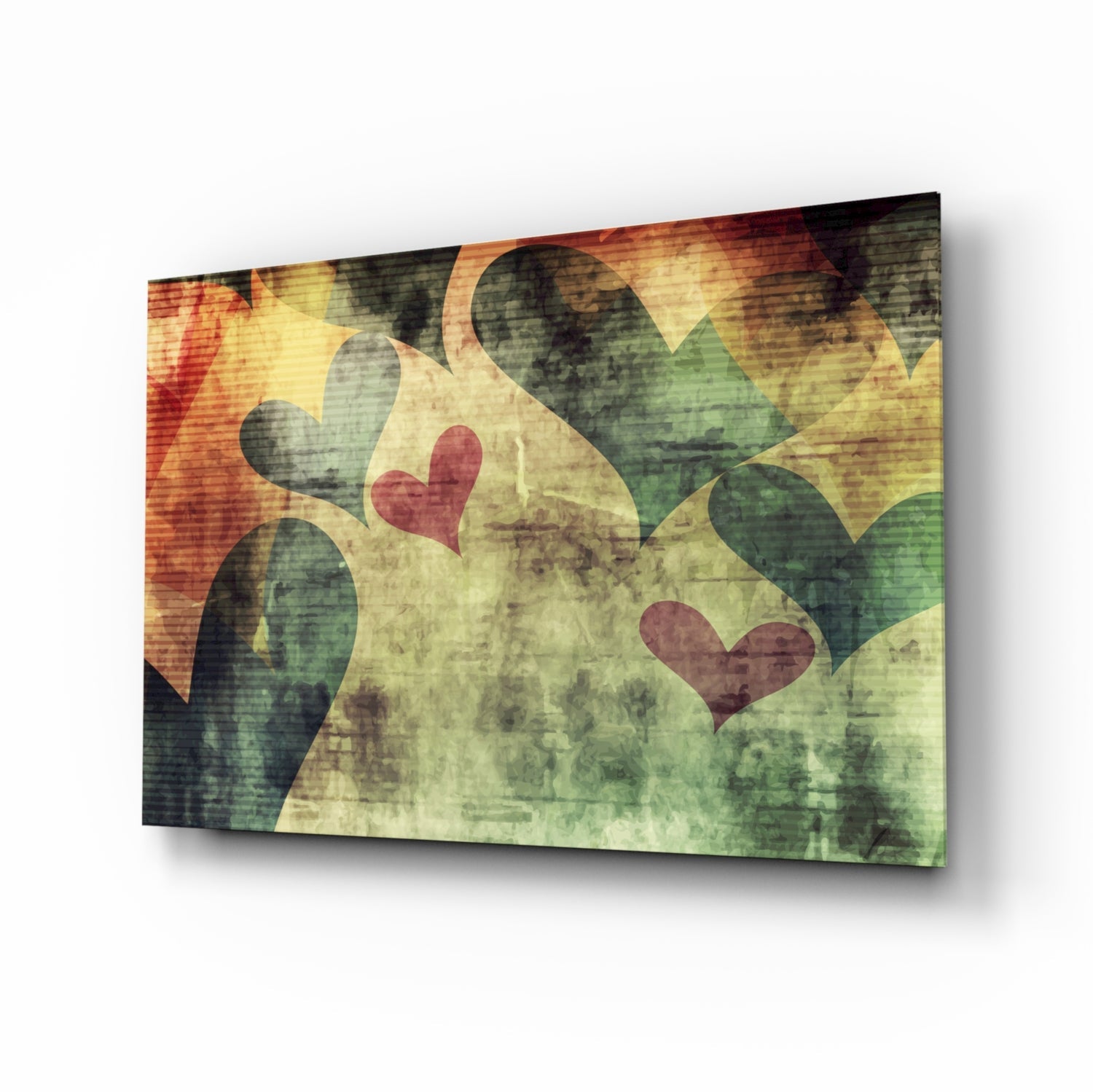 Angled view of glass wall art featuring overlapping hearts in red and dark tones on a grunge-textured background with warm yellow and green hues.
