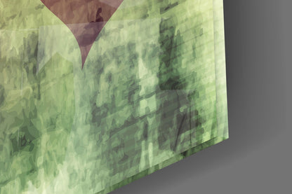 Close-up angled view of translucent green glass wall art with layered heart cutouts and burgundy accent, showing surface texture and depth.